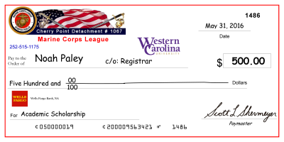 image of large-scale mock check presented to previous scholarship recipient, Noah Paley